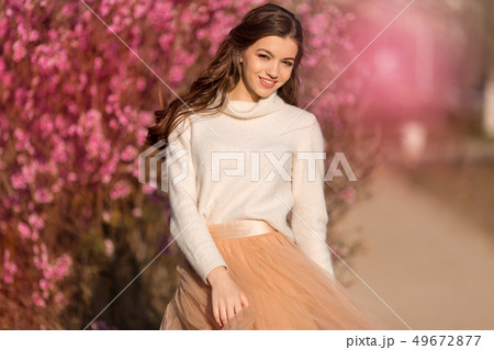 Happy beautiful teen girl with perfect skin and makeup is wearing romantic clothes posing near Happy beautiful teen girl with perfect skin and makeup is wearing romantic clothes posing near 49672877