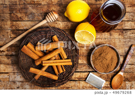 Honey and cinnamon on a wooden table Honey and cinnamon on a wooden table 49679268