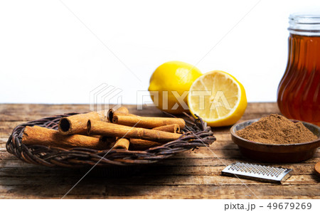 Cinnamon with dried lemon on wooden table Cinnamon with dried lemon on wooden table 49679269