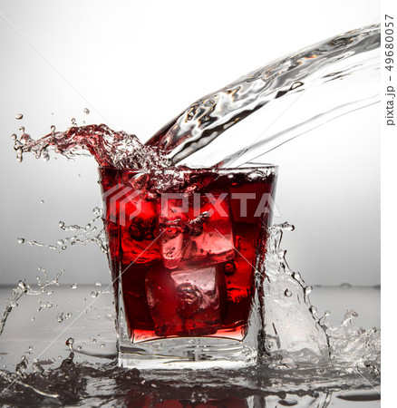 glass with ice and liquid splash glass with ice and liquid splash 49680057
