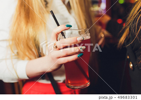 Woman's hand holds a glass of light beer. Close up. 49683301