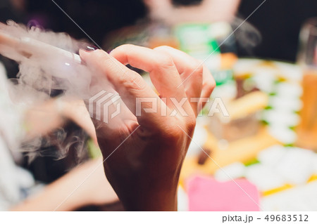 Electronic cigarettes, technology cigarette. Tobacco system IQOS. female hand on blurred background 49683512