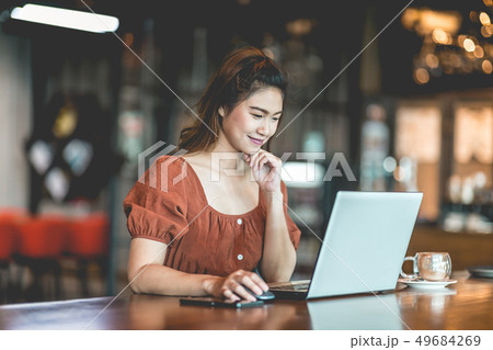 woman working with computer laptop and thinking to 49684269
