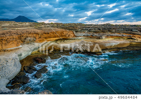Cove at sunset with cloudscape and rocks 49684484