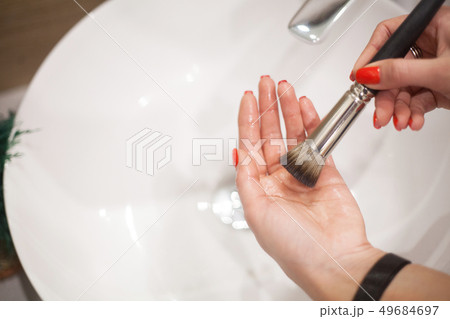Makr up brush. Woman washing dirty makeup brush with soap and foam in the sink Makr up brush. Woman washing dirty makeup brush with soap and foam in the sink 49684697