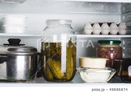 Open refrigerator with food in kitchen. Food in 49686874