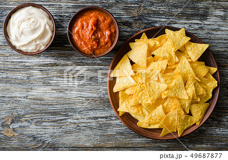 Nachos corn chips with spicy tomato and cheese sauces. Nachos corn chips with spicy tomato and cheese sauces. 49687877