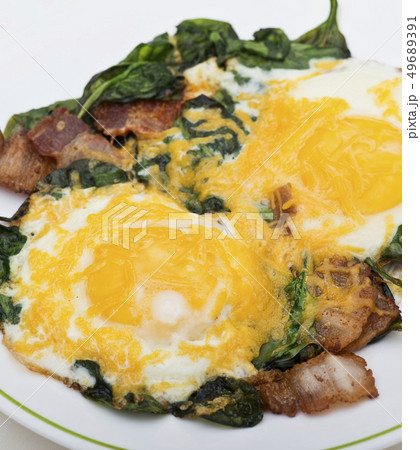 Keto diet breakfast with  eggs, spinach and bacon 49689391