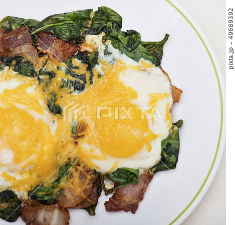 Keto diet breakfast with  eggs, spinach and bacon 49689392