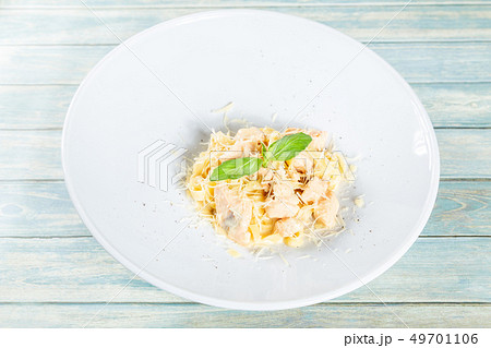 Plate of pasta fetuccini with salmon and parmesan 49701106