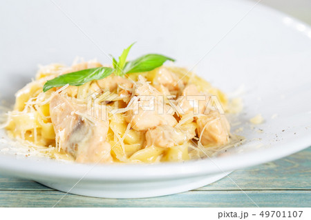 Plate of pasta fetuccini with salmon and parmesan 49701107