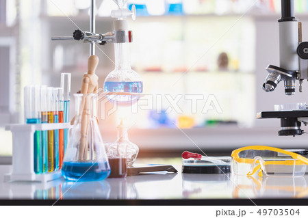 Colorful test tubes in wooden stand.. 49703504