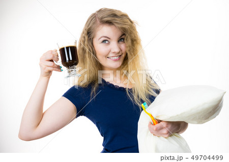 Happy woman holding toothbrush and coffee Happy woman holding toothbrush and coffee 49704499