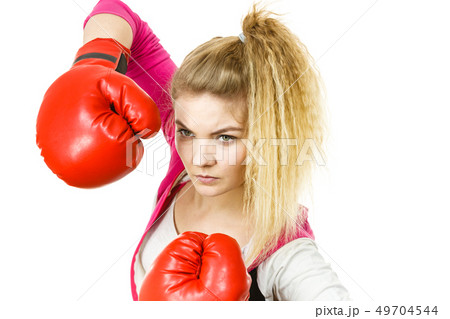 Woman wearing boxing gloves Woman wearing boxing gloves 49704544