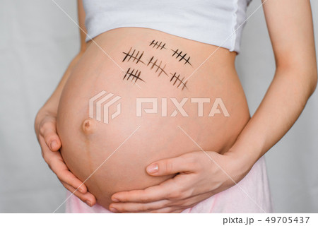 pregnant girl hugs her stomach with a term of pregnancy pregnant girl hugs her stomach with a term of pregnancy 49705437