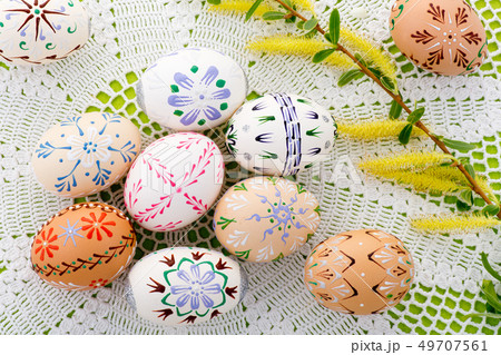 Painted Easter eggs with a blossom on the desk 49707561