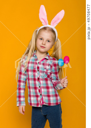 cute little girl with Easter bunny ears holding colorful eggs 49708477