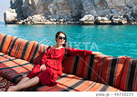 Woman having fun on a dhow boat cruise Woman having fun on a dhow boat cruise 49710225
