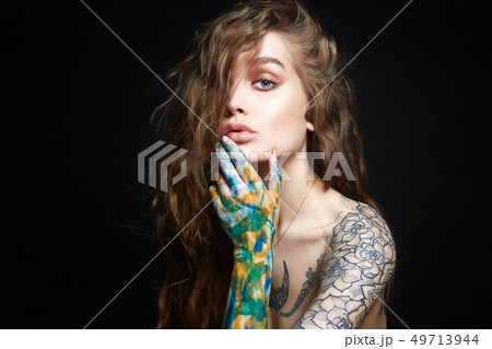 Sexy Girl with Tattoo and color paint on her Body. Sexy Girl with Tattoo and color paint on her Body. 49713944