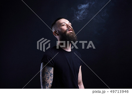 handsome Brutal bearded man in Smoke 49713946