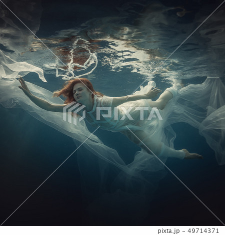 Girl in a white dress under water Girl in a white dress under water 49714371