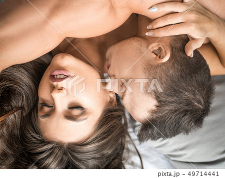 close up of heterosexual couple having sex. Man kissing woman's neck 49714441