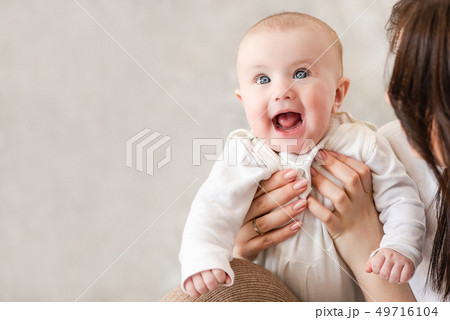 Cute infant girl smile in mama hands 49716104