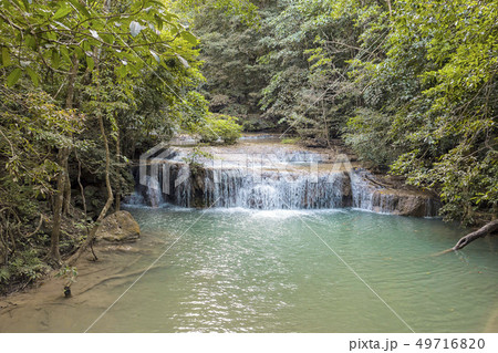 Jangle landscape with flowing turquoise water of Erawan cascade waterfall 49716820