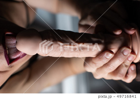 Female mouth and rubber dildo close up 49716841