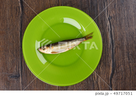 Cold smoked Baltic herring on an green plate Cold smoked Baltic herring on an green plate 49717051