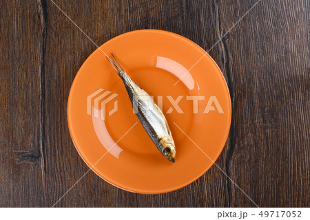 Cold smoked Baltic herring on an orange plate 49717052