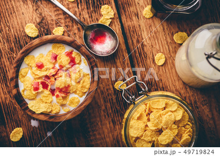 Breakfast with corn flakes, milk and berry syrup Breakfast with corn flakes, milk and berry syrup 49719824