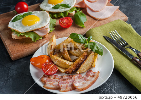 Fried potatoes and bacon on plate 49720056