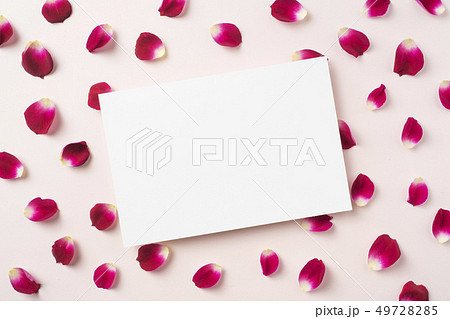 top view of red rose petal with white card 49728285