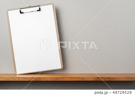 front view of A4 paper with clipboard on bookshelf 49729529