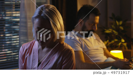 Couple crying in bed at night Couple crying in bed at night 49731917