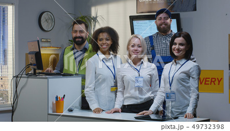 Delivery center employees standing by desk Delivery center employees standing by desk 49732398