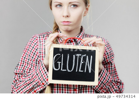 Angry woman holding board with gluten sign 49734314