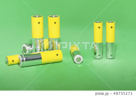 AA batteries on green background. Concept of recycling AA batteries on green background. Concept of recycling 49735271
