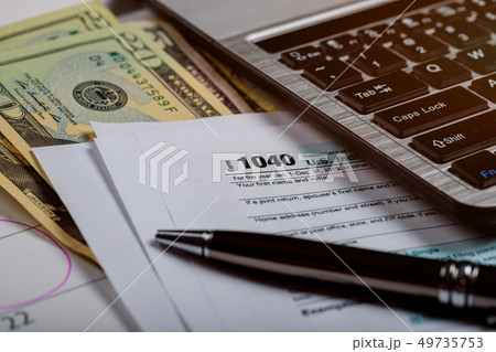 1040 US tax form, money and calendar with U.S 49735753