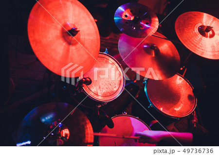 Drummer playing drum set at concert on stage. Music show. Bright scene lighting in club,drum sticks Drummer playing drum set at concert on stage. Music show. Bright scene lighting in club,drum sticks 49736736