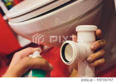A plumber fixes a water faucet on a water pipe. Pepair plumbing background. A plumber fixes a water faucet on a water pipe. Pepair plumbing background. 49736747