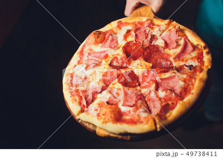 Young woman holding plate with tasty pizza, close up view. Young woman holding plate with tasty pizza, close up view. 49738411