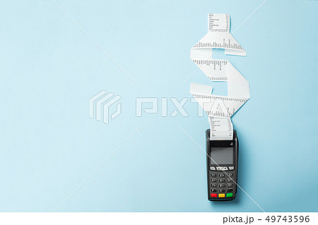 Terminal cash register machine POS for payments and long roll paper cash tape in shape of dollar Terminal cash register machine POS for payments and long roll paper cash tape in shape of dollar 49743596