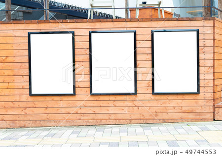 Large blank billboard on a street wall, banners 49744553