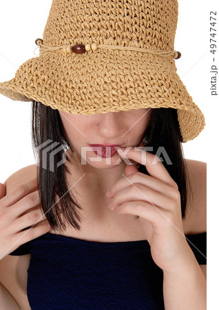 Mysterious woman with big straw hat in close up Mysterious woman with big straw hat in close up 49747472