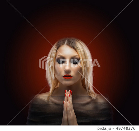 portrait of a blond woman. evening make-up on the red background 49748276