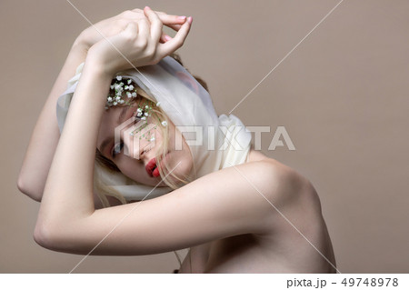 Fashion model with white silk fabric on hair showing nice poses Fashion model with white silk fabric on hair showing nice poses 49748978