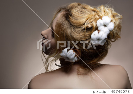 Professional promising model posing with cotton in her hairstyle Professional promising model posing with cotton in her hairstyle 49749078