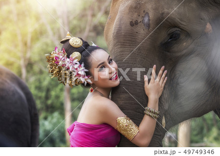 Pretty thai girl in traditional thai dress Pretty thai girl in traditional thai dress 49749346